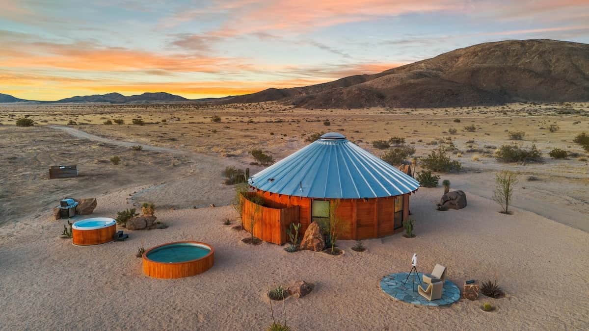 Your quarter-mile of Mojave from above — the yurt, cedar spa, cowboy pool, and stargazing pad, with