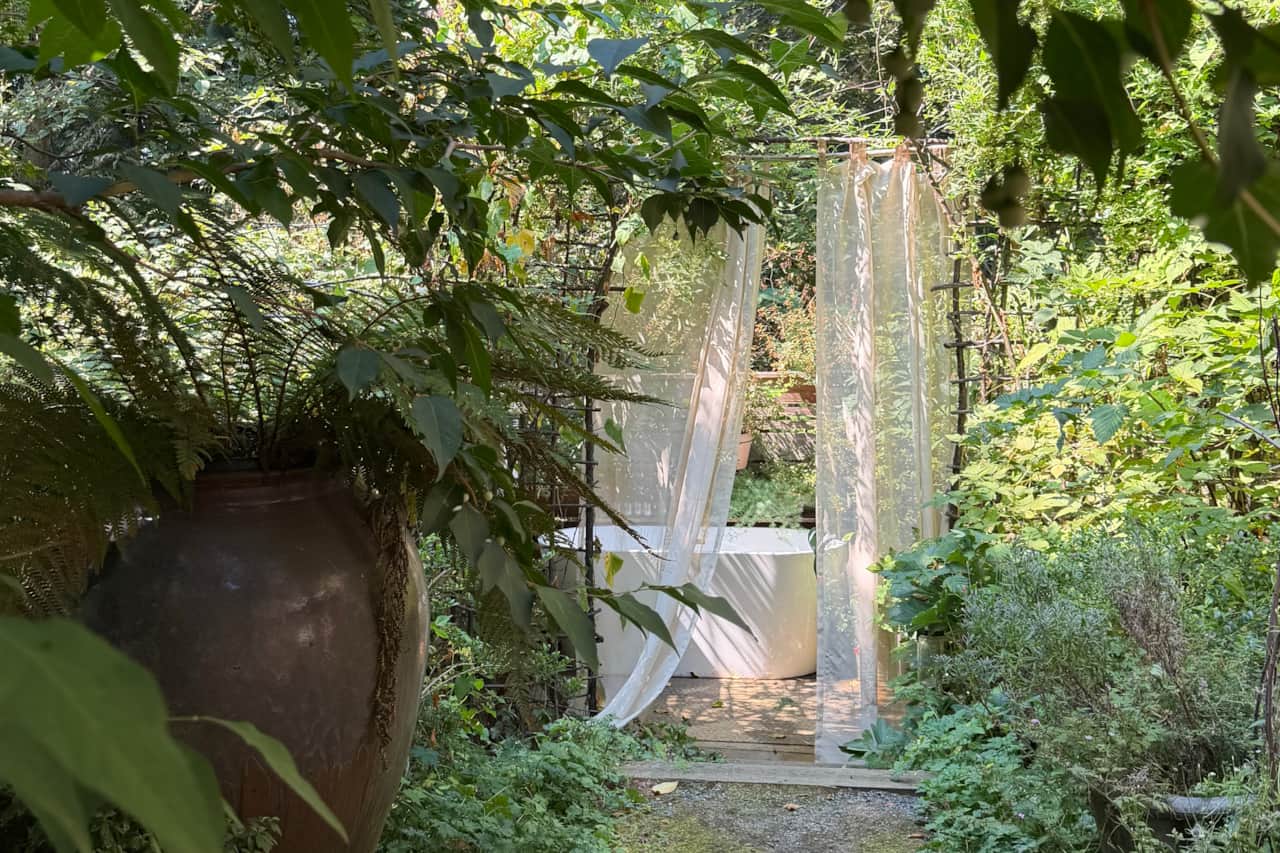 A private outdoor soaking tub tucked into the garden