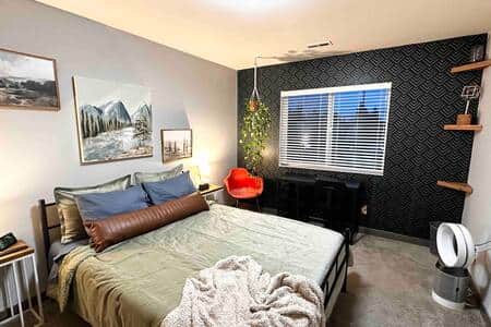 Large room with queen bed, mini fridge, microwave and TV all logged into streaming platforms. 
