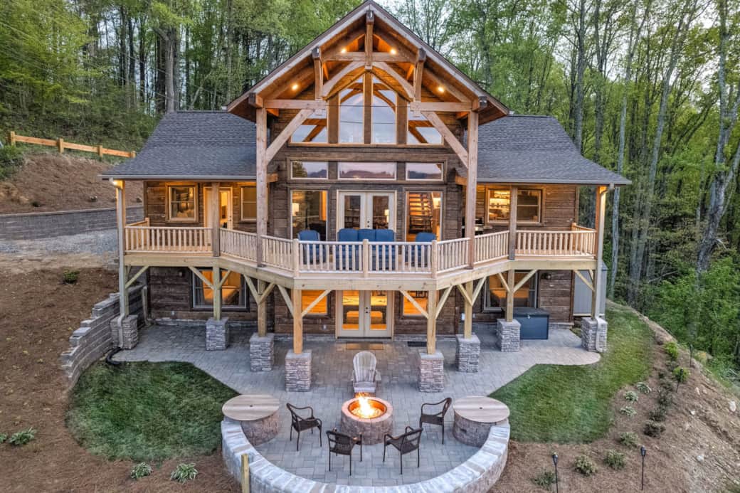 Rear patio showcases breathtaking mountain vistas with cozy fire pit for evening relaxation
