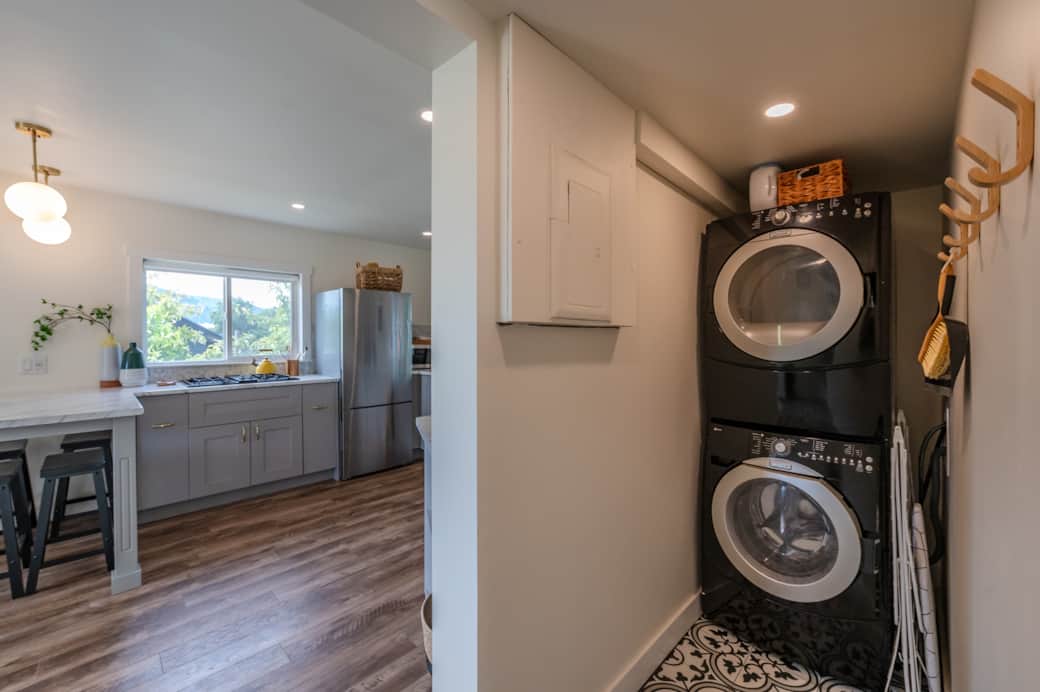 Washer & Dryer leading into the open kitchen & living room