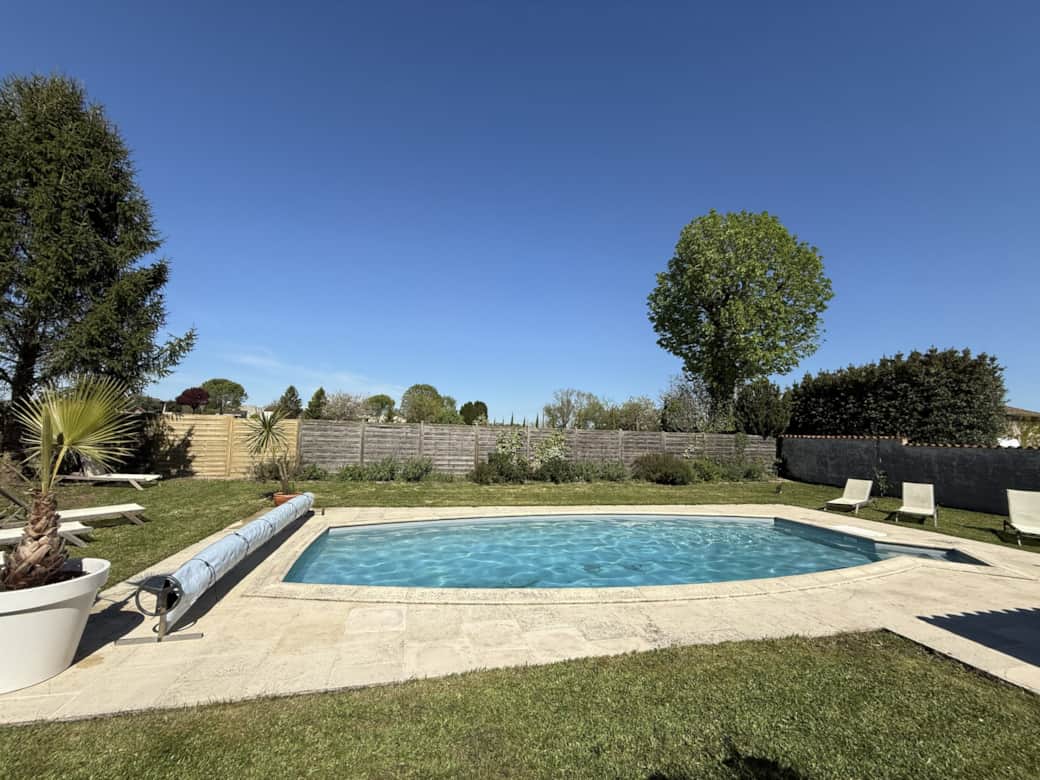 Private swimming pool with secure access and a pool house