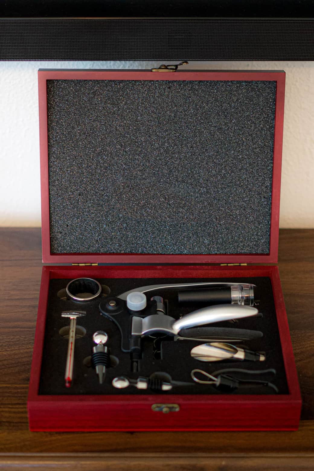 Curated wine accessory set for guests — includes corkscrew, pourer, stoppers, and essentials for enjoying a glass of wine at home.