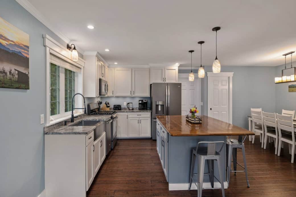 The large kitchen island provides ample space for creating meals together. It also boasts extra seating for 4.