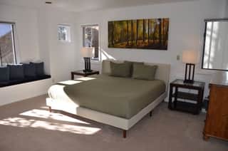 Primary bedroom with a king-sized bed and ensuite bath Primary bedroom with a king-sized bed and ensuite bath