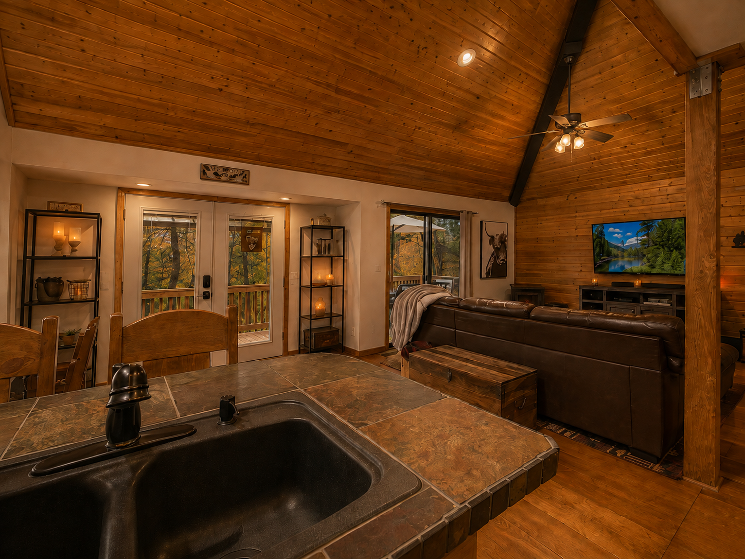 Open-concept cabin view from kitchen into living and dining space