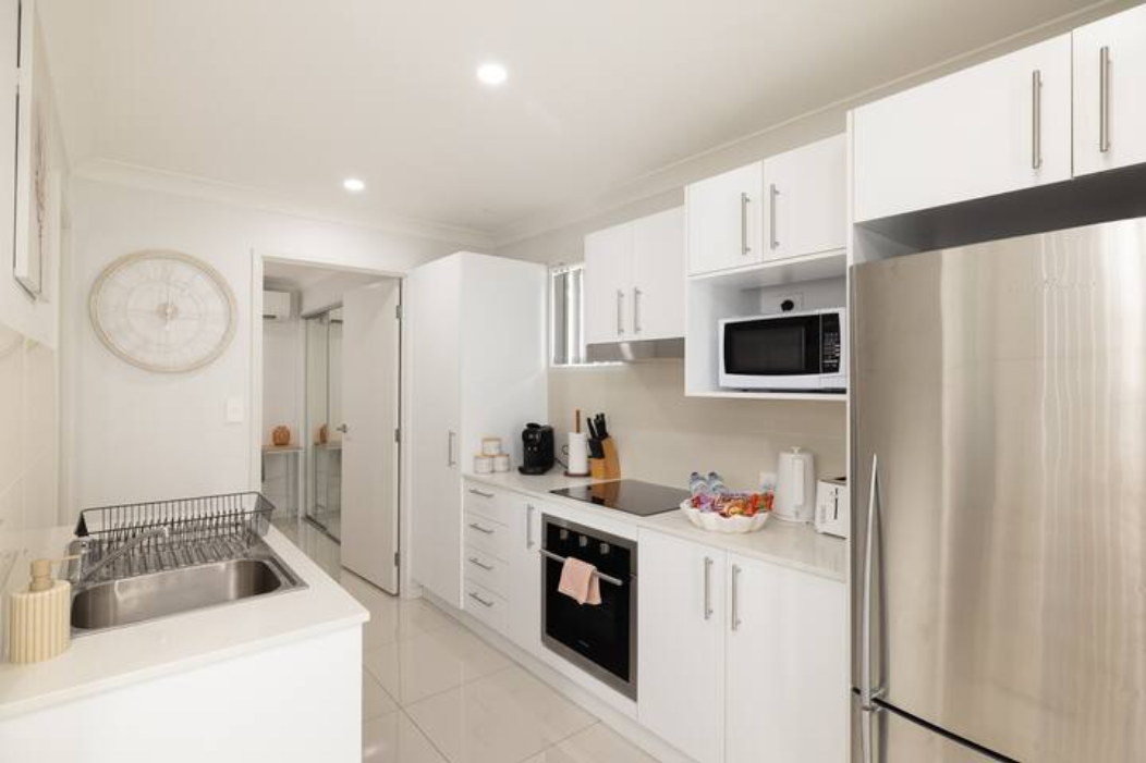 Kitchen: Sleek kitchen with ample storage, modern appliances 