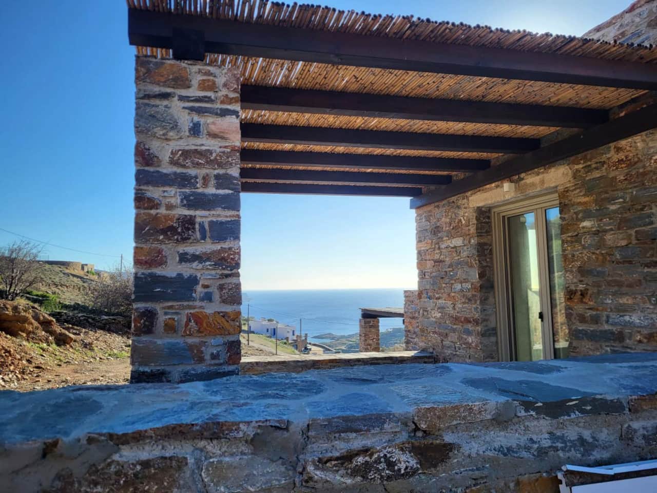 Aegean Sea view framed between traditional stone walls, Koundouros, Kea