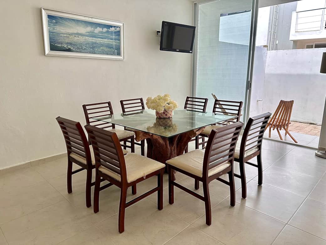 Open living space: living room, kitchen, dining area, patio
