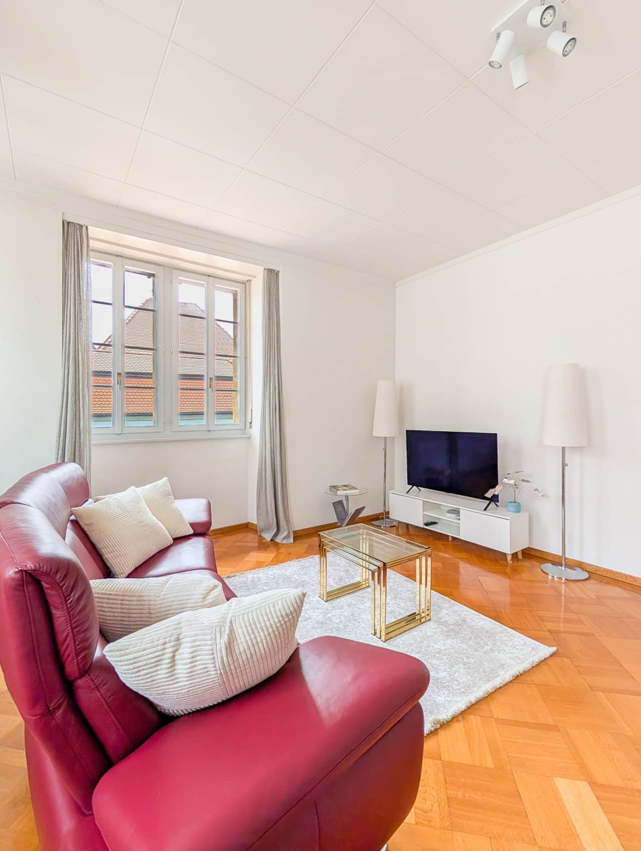 Bright living room area with television.