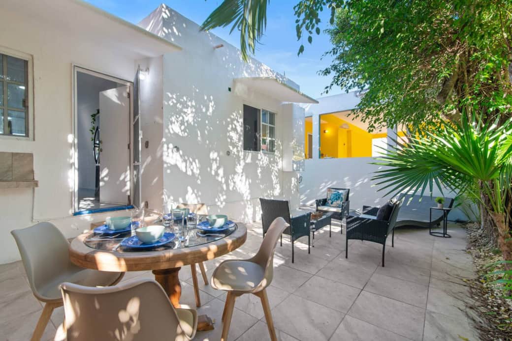 rivate back patio with outdoor dining furniture for enjoying meals, plus a comfortable chaise lounge in the corner—perfect for relaxing or reading.
