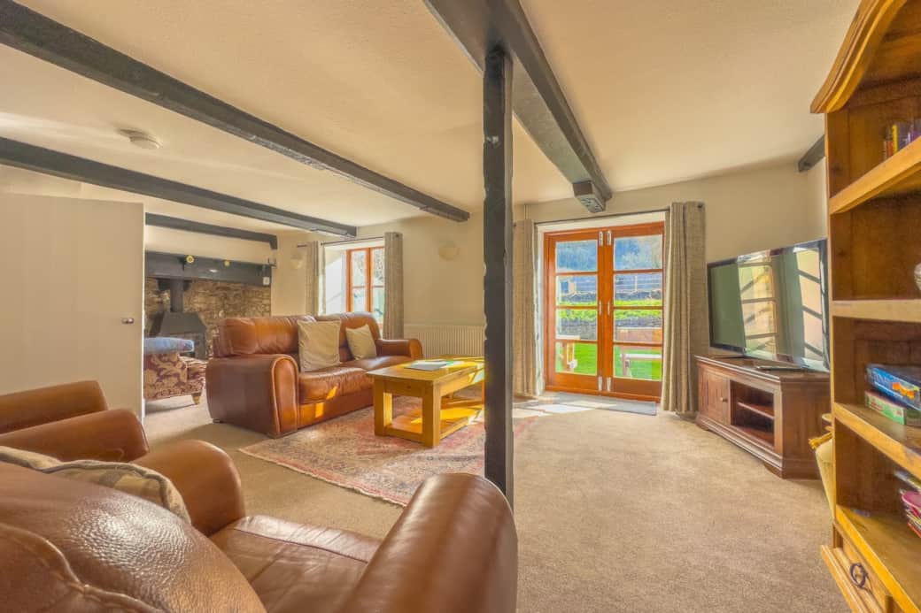 living room, with tv, netflix, boardgames, fireplace, garden view, french doors opening to garden