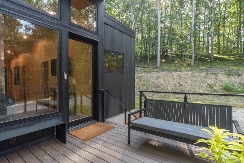 The Hemwood's modern cabin design with large windows brings the woods inside, while the cozy exterior hangout spot is the perfect place to relax and take in the view.