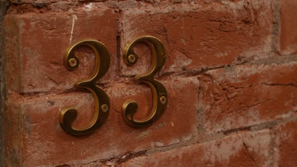A quiet number on warm brick guiding you home .
