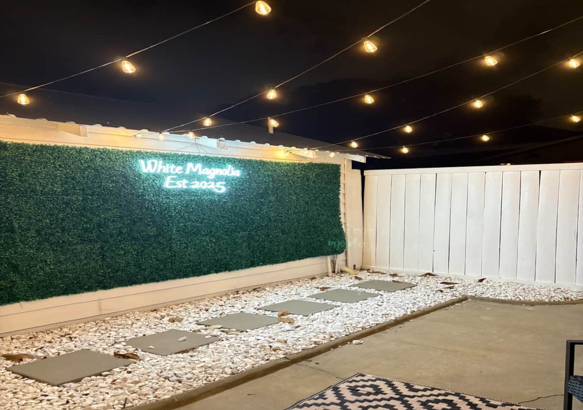 Game lounge and pictures in front of the photo wall at White Magnolia Galveston