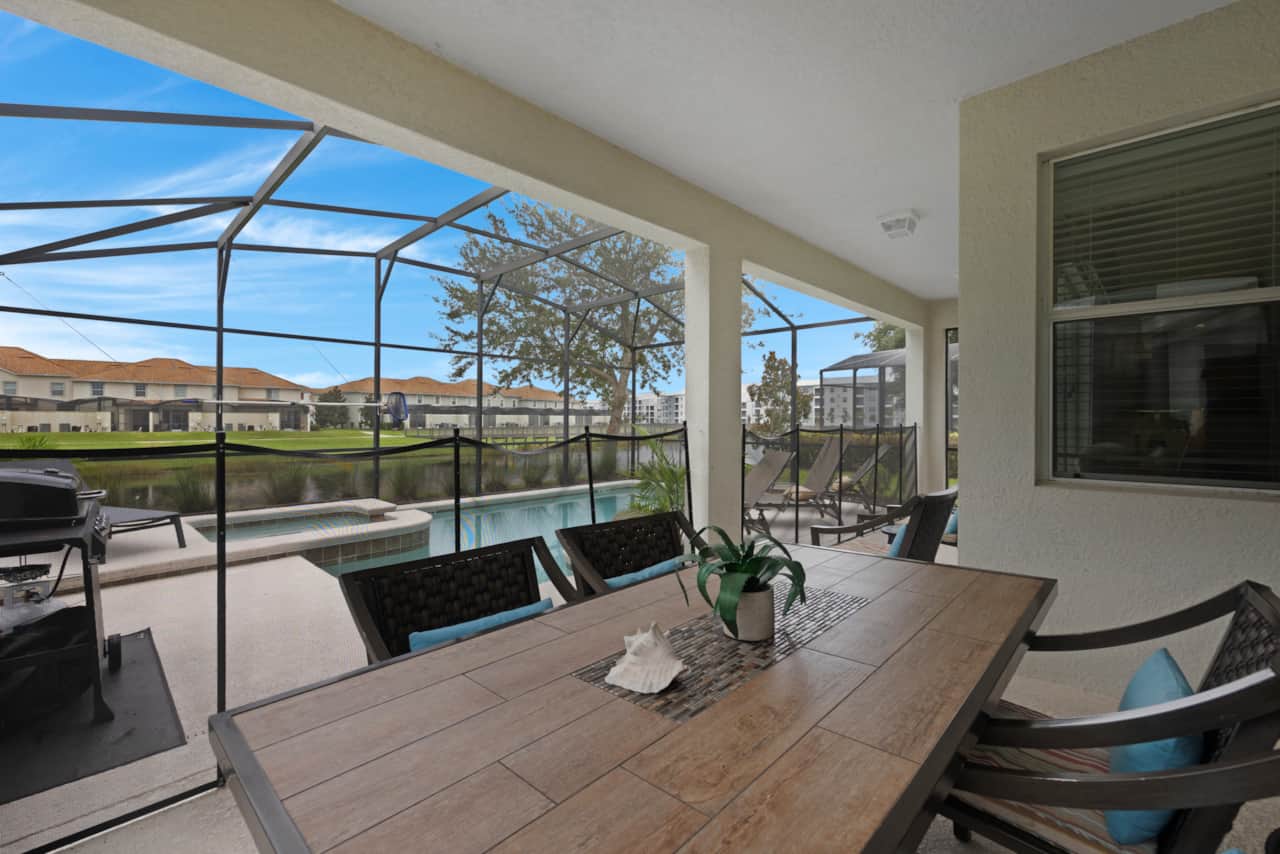 The sliding glass door opens to a covered, screened patio with dining for 6 