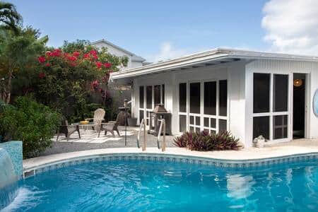 Pool with water feature and intimate seating nearby.