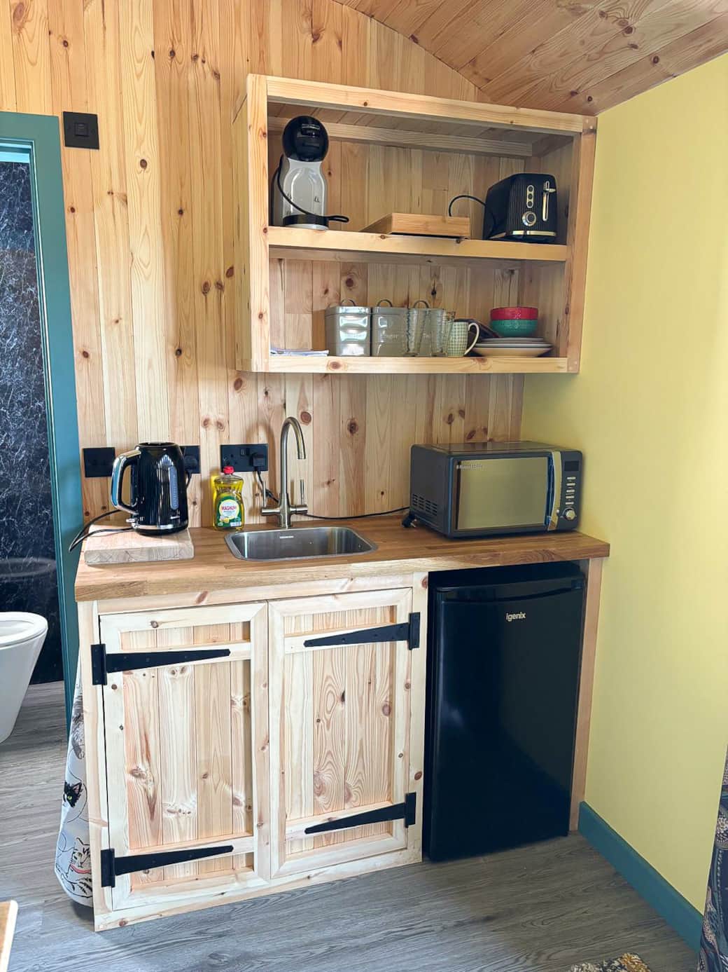 Fully equipped kitchenette with fridge, microwave, kettle and coffee machine.