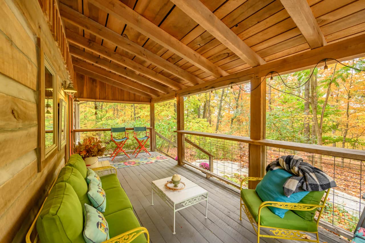 Take a deep breath, sit a spell and take in the views of nature surrounding the cabin.  Colorful vintage wrought iron furniture, painted directors chairs, and a bar top surrounding perfect for wildlife and nature viewing. 