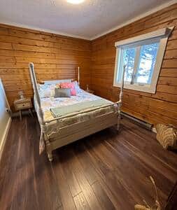 This bedroom includes a comfortable; bed, pillows, lovely linens and luggage racks. Bay views too!