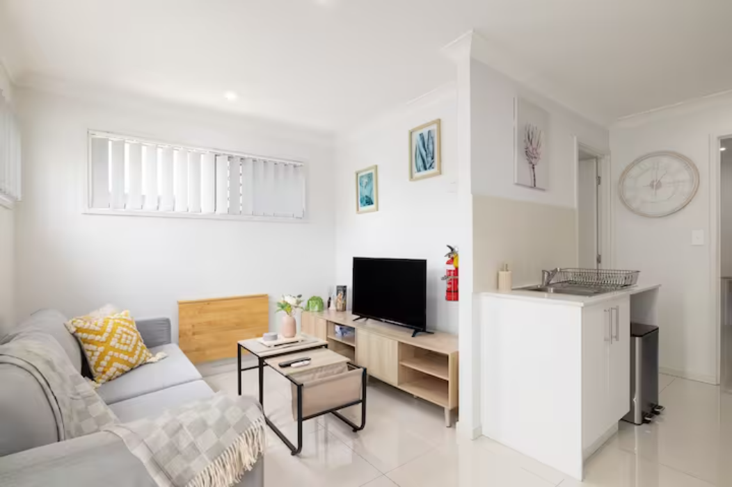 Living Area: Bright living space with comfortable seating and TV 