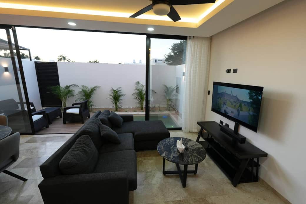 Bonita Sala abierta en área abierta con vista a la terraza, alberca, comedor y cocina. 