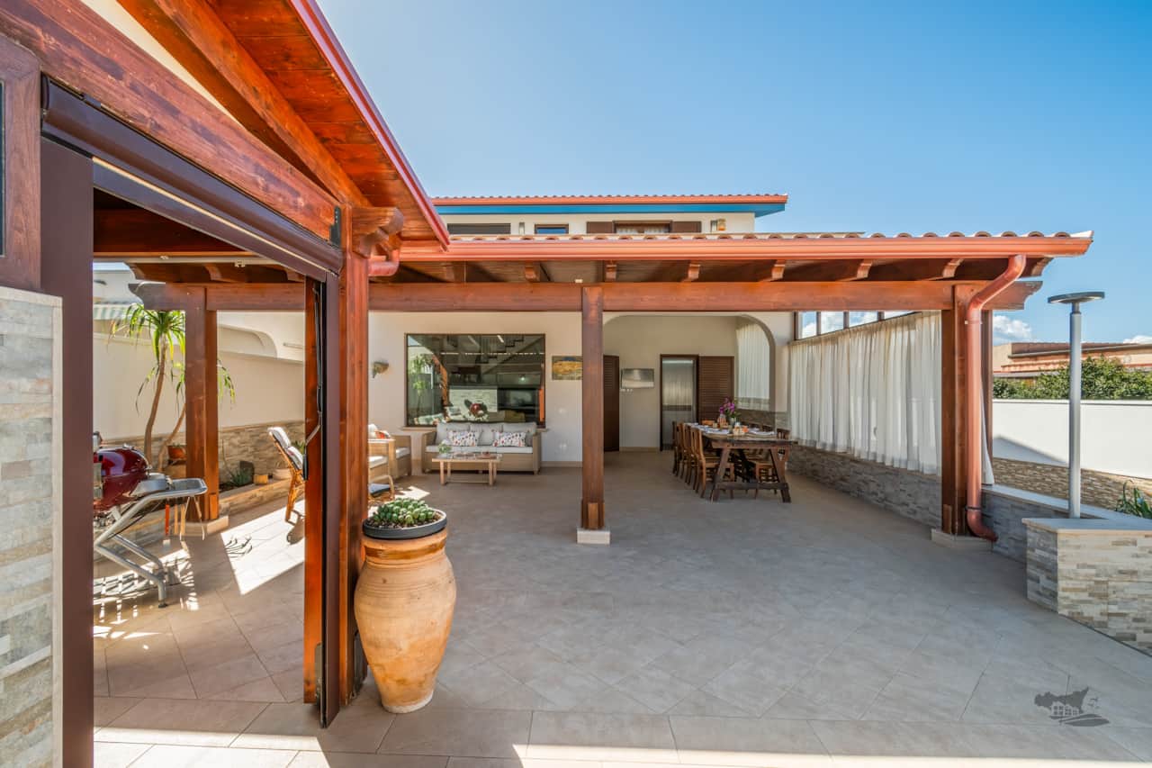 The charming patio invites you to unwind in a cozy, sheltered space. 