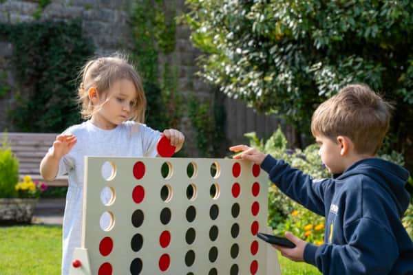 Children playing a garden game in the walled Secret Garden