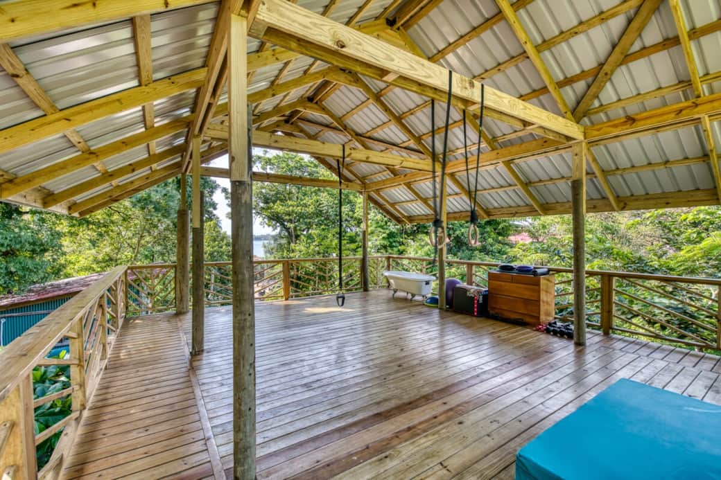 Open-air yoga deck with panoramic views of Isla Carenero & Bastimentos — your eco lodge island getaway in Bocas del Toro, Panama, elevated above the jungle canopy.
