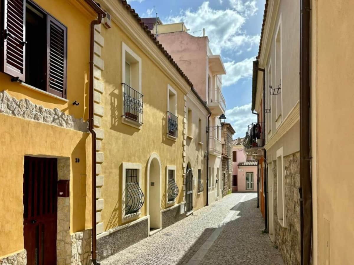 Traditional carousel and families at Olbia waterfront promenade