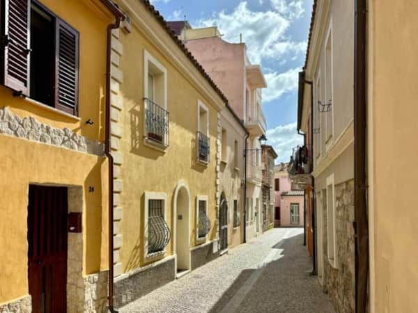 Traditional carousel and families at Olbia waterfront promenade — photo by RENTAL12