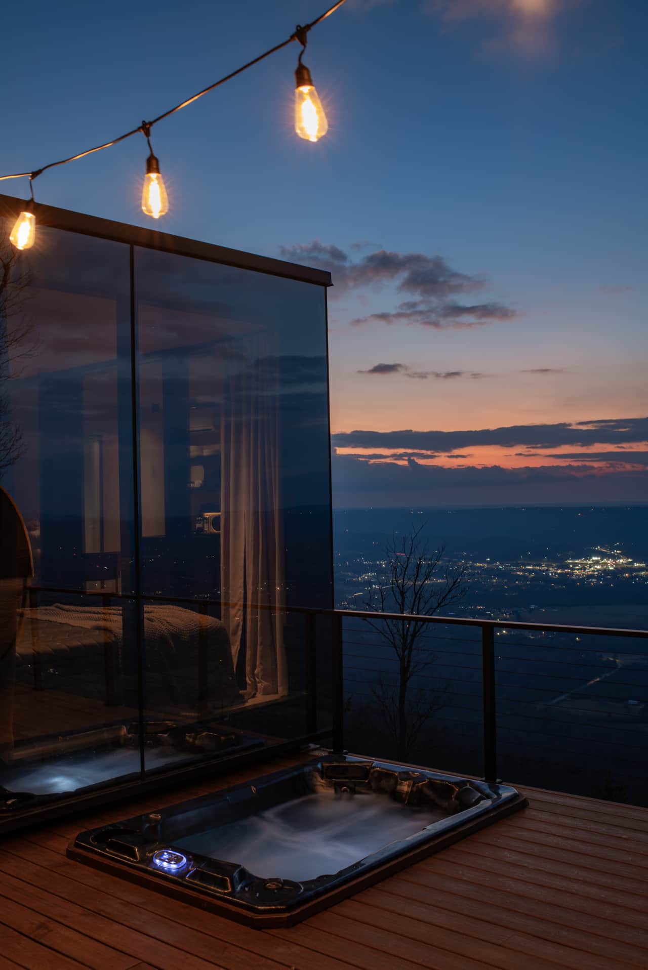 Sunken hot tub set into the deck, offering a relaxing soak with panoramic mountain views.