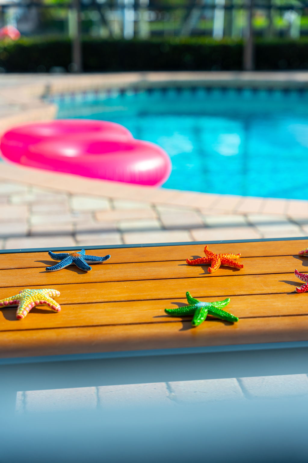 Unwind by the pool, surrounded by playful like colorful inflatables.