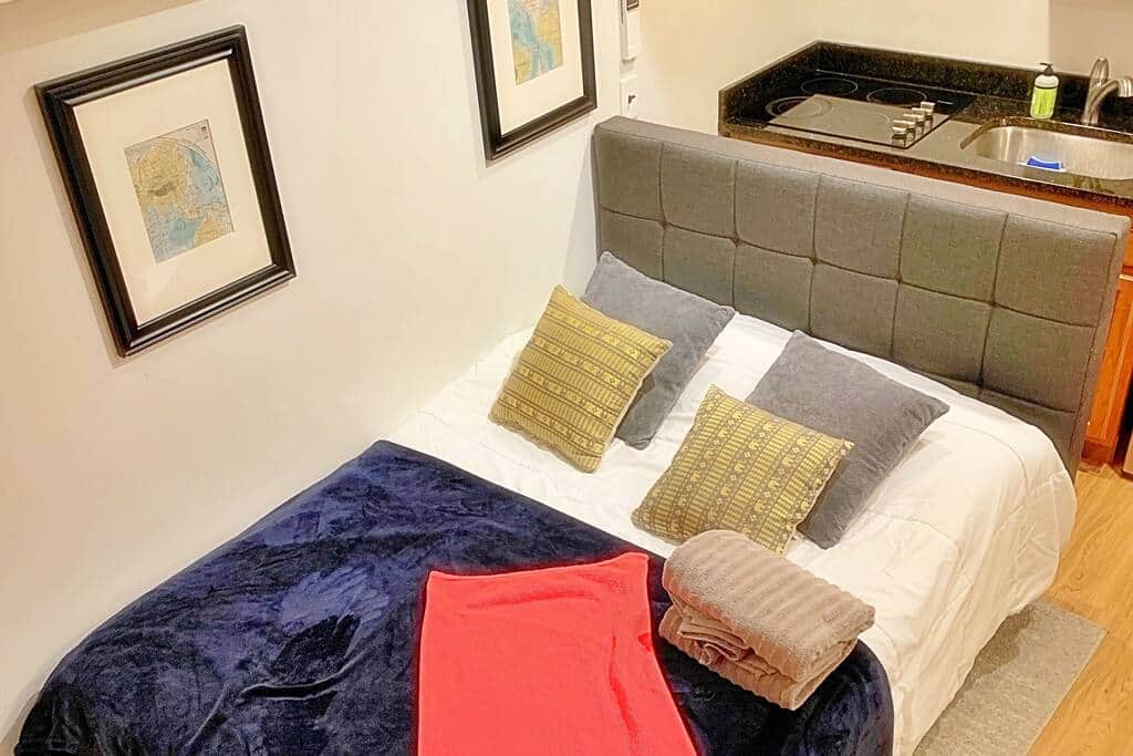 Queen-size bed and a granite top counter in the kitchen