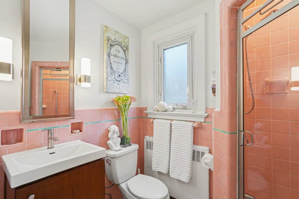 Private 3-piece ensuite bathroom featuring a classic pink tile design Private 3-piece ensuite bathroom featuring a classic pink tile design