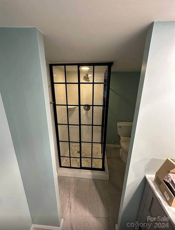 Recently updated downstairs bathroom with a beautiful tiled shower and glass enclosure. Recently updated downstairs bathroom with a beautiful tiled shower and glass enclosure.