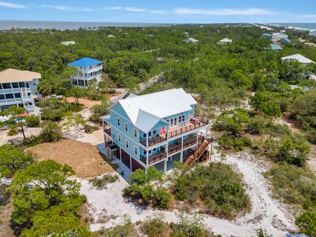Aerial view of rear of house with bay in background