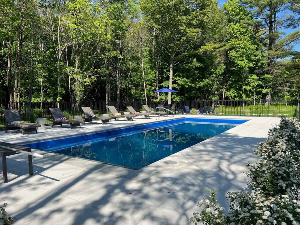 Swimming pool with lounge chairs in the backyard