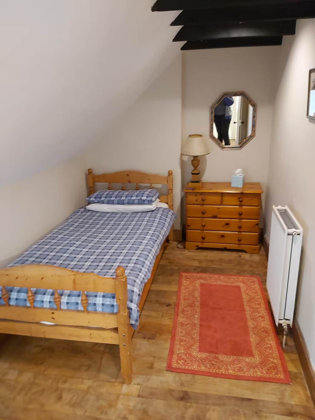 Single bedroom with chest of draws and chair