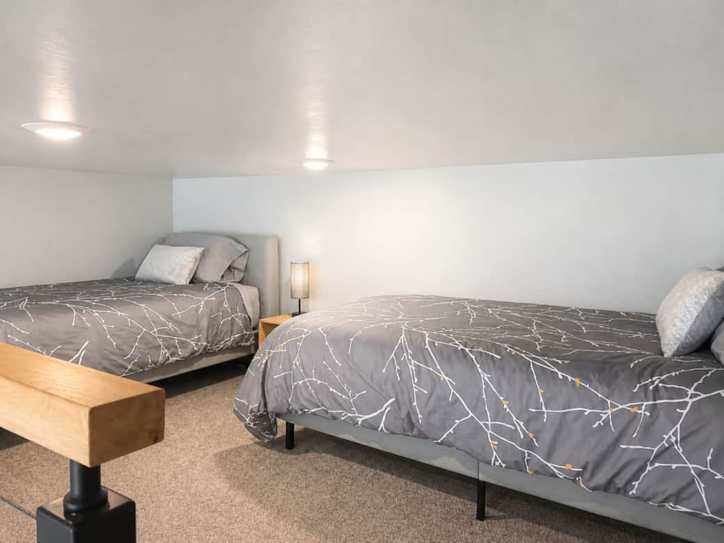 Sleeping loft with two twin beds and premium linens in the Black Hills, SD.