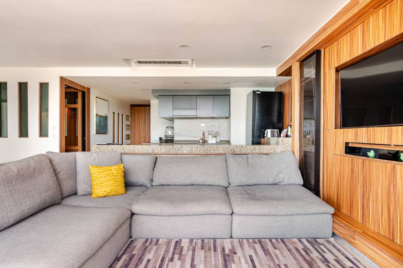 Sala amplia con vista al mar y Smart TV curva.
