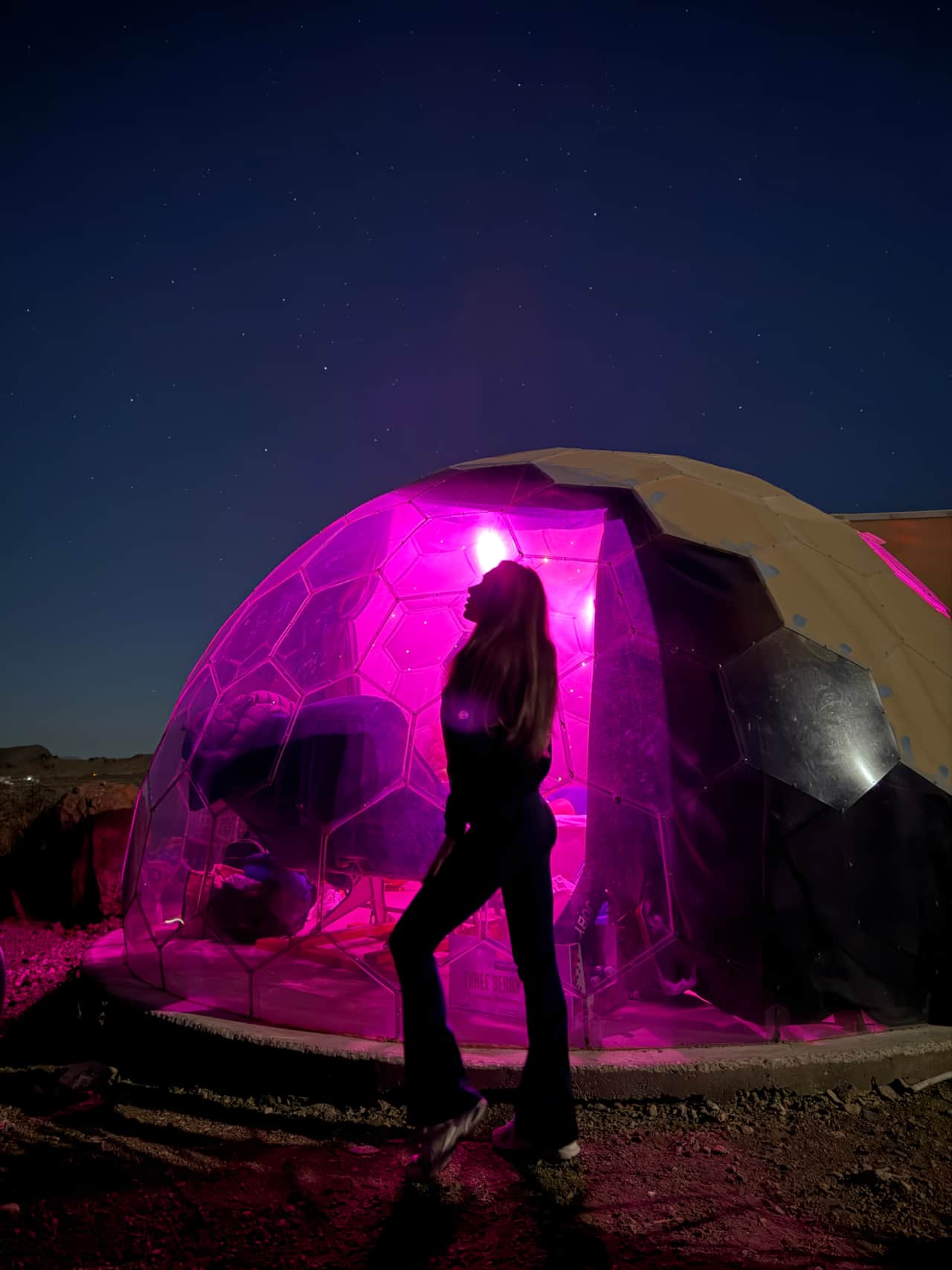 Space Pod 002 dome glowing pink at night