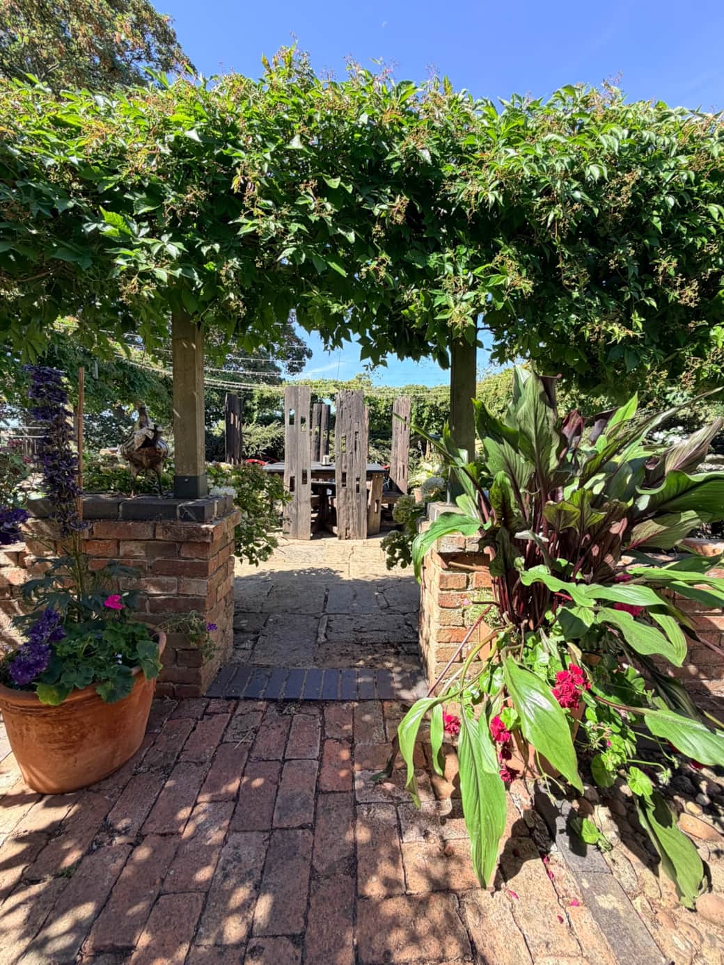 The entrance to the bbq area surrounded by lovely flowers