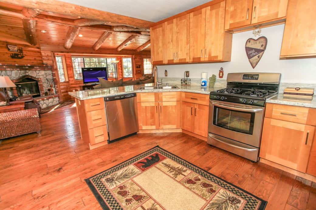 Wood finished cabinetry, stainless steel appliances and rustic decor give this kitchen a modern, cabin feel. Wood finished cabinetry, stainless steel appliances and rustic decor give this kitchen a modern, cabin feel.