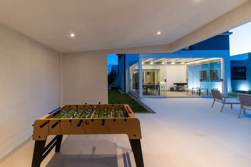 Foosball table by the pool lounge at Alba Family Home