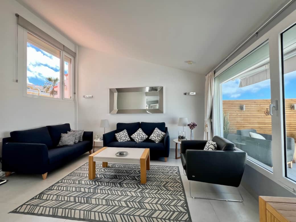 Bright, open-plan living area with large windows and a relaxed, comfortable feel Bright, open-plan living area with large windows and a relaxed, comfortable feel