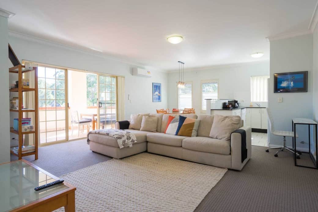 Light filled open plan living area with fully functional kitchen, dinning set, lounge, desk with Bos