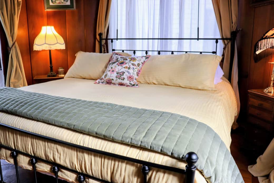 King bed with backyard views and a glimpse of downtown Nevada City