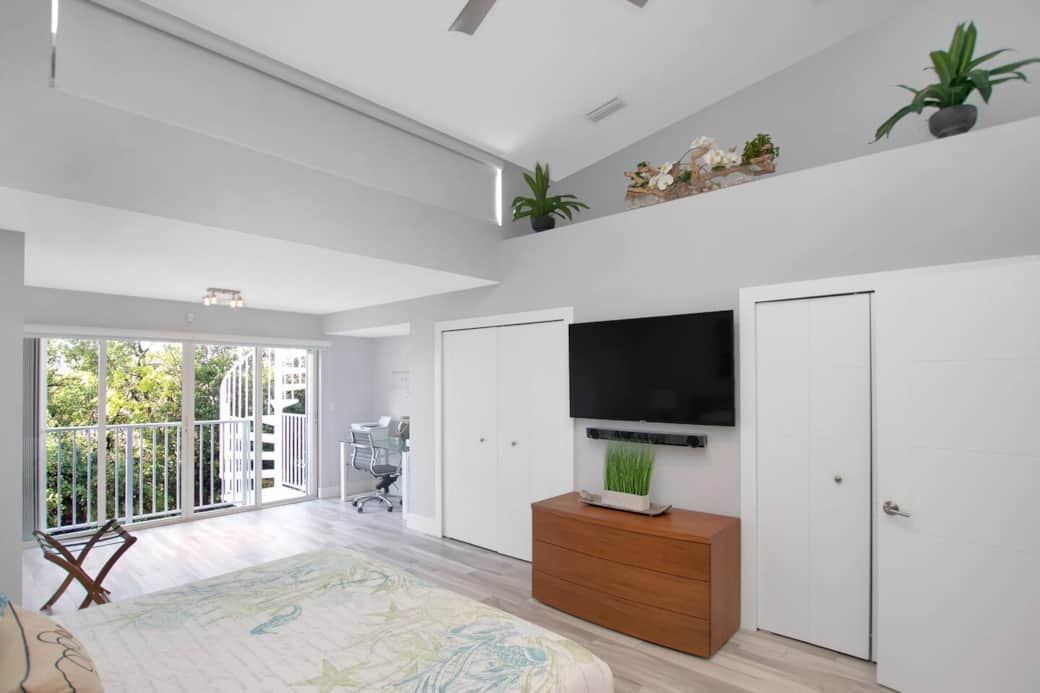Main Bedroom with flat screen Tv and a view outside.