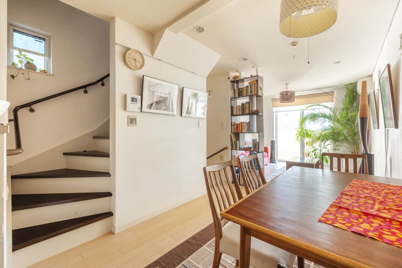 Well lit dining area with easy access to staircase and book shelves